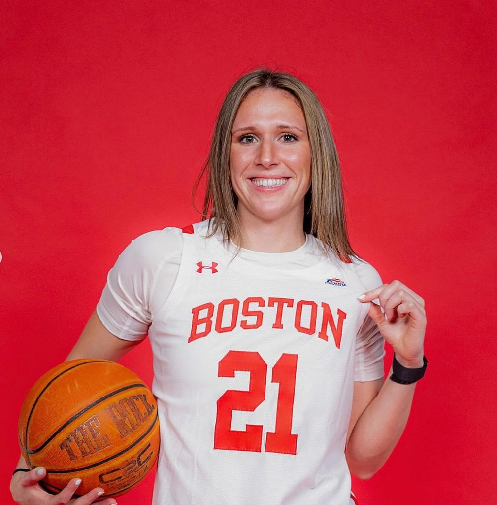 Boston University student athlete Audrey Erickson (COM'27) in her women's basketball uniform, with a basketball in hand. 